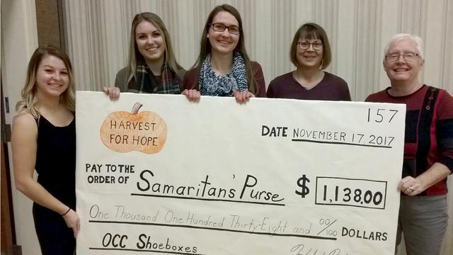 Durham College students present a cheque to Relief Society president Carolyn Johnston to pay for shipping shoebox gifts to needy children: (left to right) Jessica Walton, Amanda Nagy,  Katelyn Stachow, Carolyn Johnston, Pam Barter.